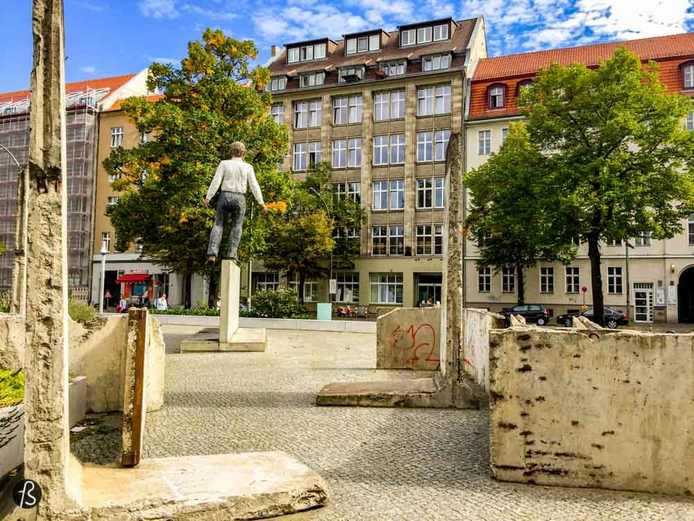 When people visit Berlin for the first time, they find time to visit Checkpoint Charlie. But what is around Checkpoint Charlie is better! Balanceakt is the name of this sculpture created by German sculptor Stephan Balkenhol. The artwork shows a man standing on an original piece of the Berlin Wall, like it is trying to balance itself from falling on any of the sides.