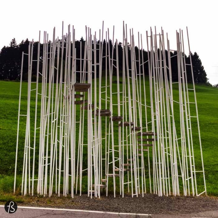First, let's talk about the amazing work for japanese architect Sou Fujimoto that created a bus stop that looks like a forest of thin steel rods that barely support a winding staircase. His design follows the concept that architecture shouldn’t adapt itself to nature and it shouldn’t imitate it as well. Because of this philosophical approach to a bus stop, it doesn’t have a protecting function anymore. Their intention was to come up with a bus stop where people can meet and enjoy the view. As well as function as a landmark to the village, something that we are pretty sure it does really well.