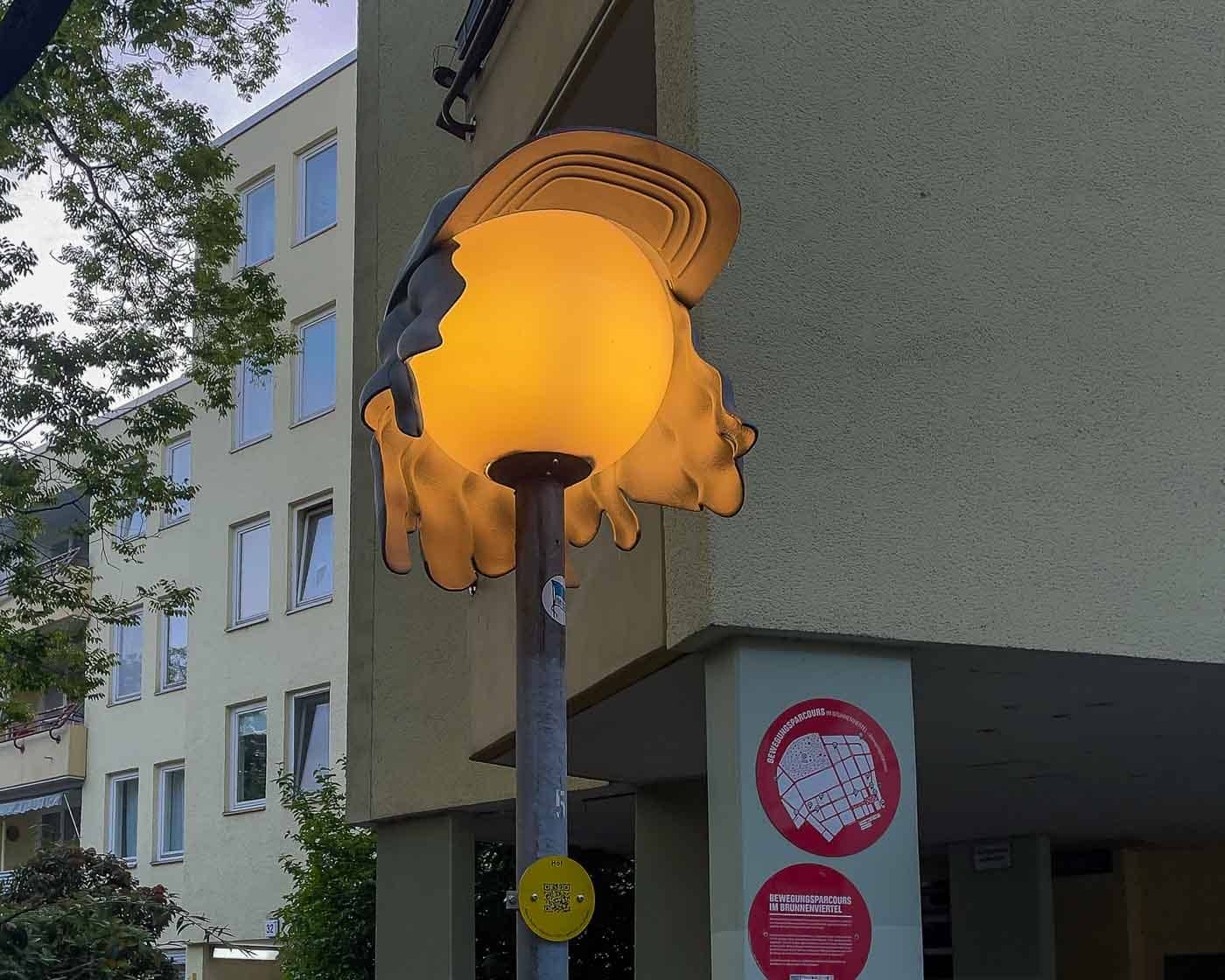 On the border of Mitte and Wedding lies Brunnenviertel, a neighborhood renowned for its inviting green spaces and tranquil, pedestrian-friendly courtyards. As dusk settles, a soft, romantic glow emanates from the area's distinctive spherical streetlamps. But there's a clever twist to that. Look closely, and you'll discover that many of these lamps are wearing hats. These are the Nightcaps, a brilliant public art installation that is both functional and fantastical.